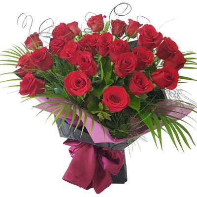 Red flower bouquet of roses red, red orchids, red gerberas, red tulips in large red bouquet with red wrapping and ribbon.