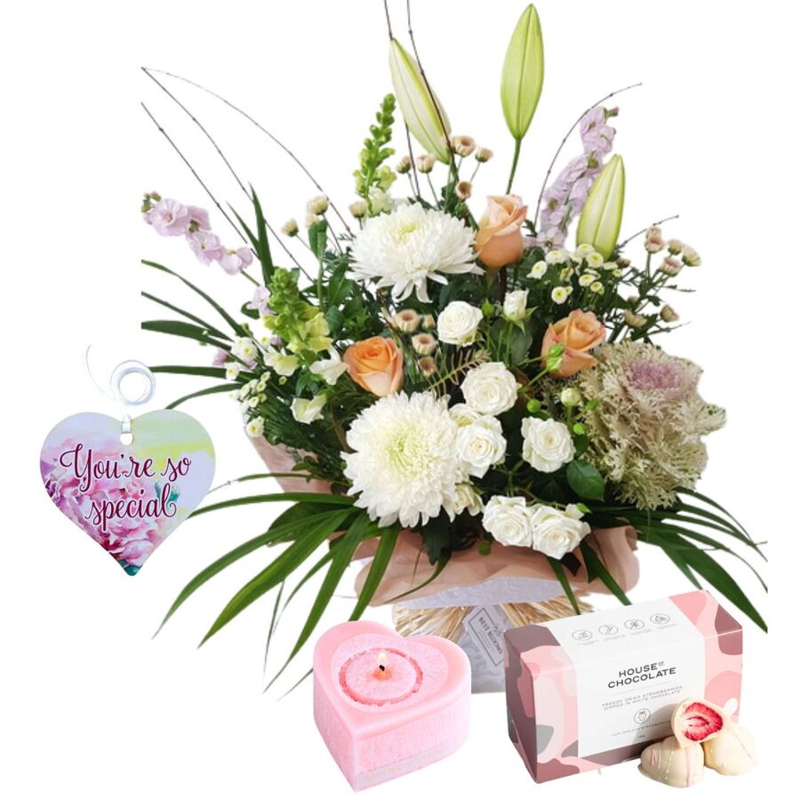 Romantic anniversary gift combo with pastel flowers, candle and chocolates