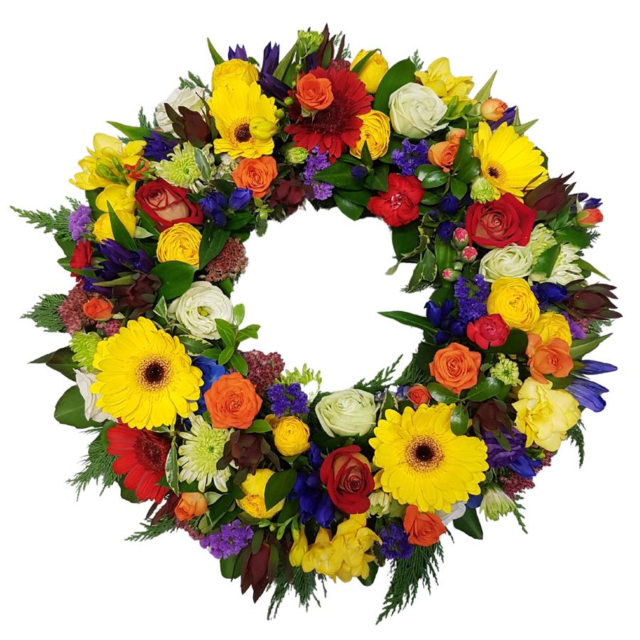 Bright colourful wreath Auckland NZ. Assorted bloom design of seasonal colourful flowers. Gerberas, roses, freesias, carnations leaves in wreath.
