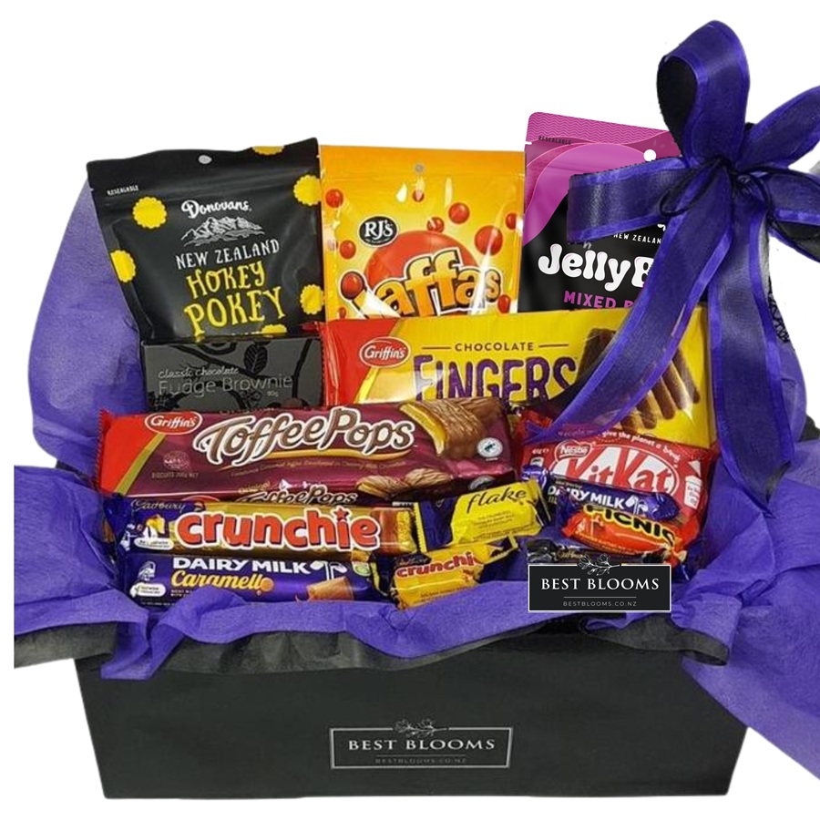 Chocolate gift basket packed with assorted Cadbury-style treats wrapped in purple for Auckland delivery.
