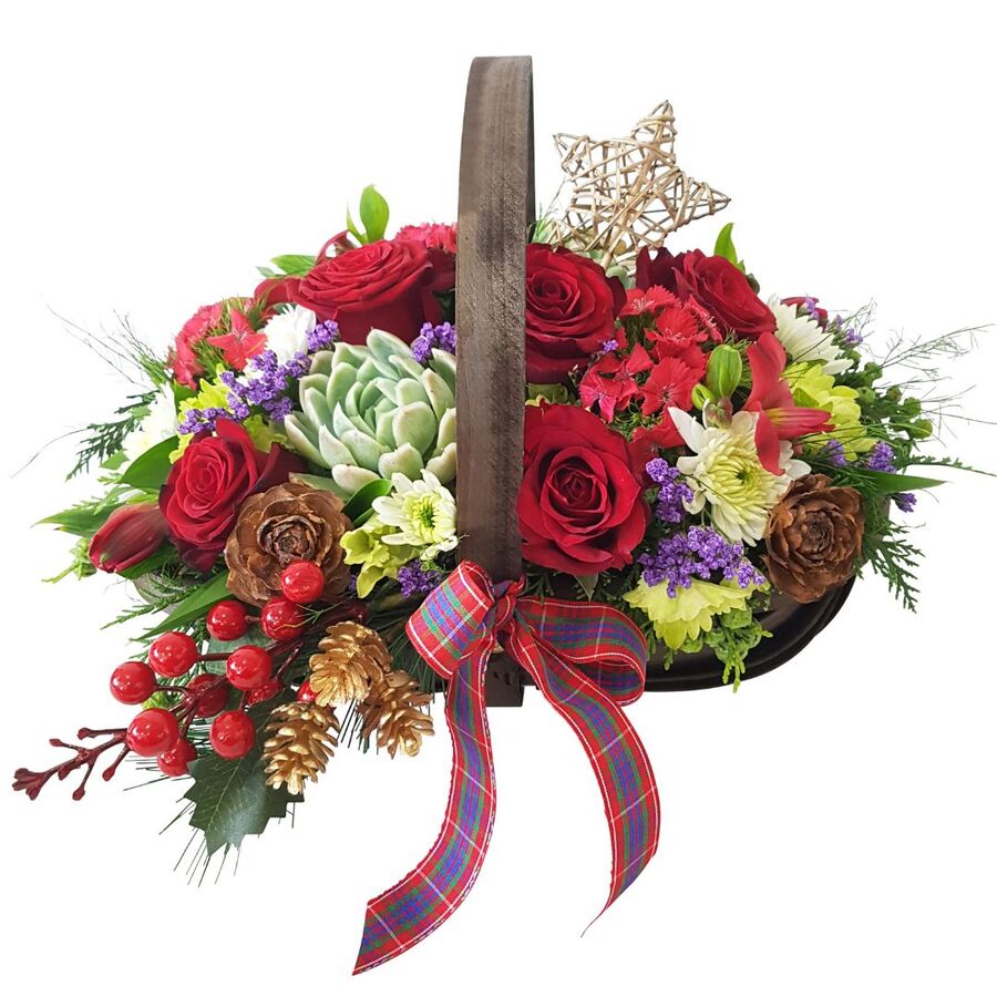 Christmas floral design in rustic wooden trug basket