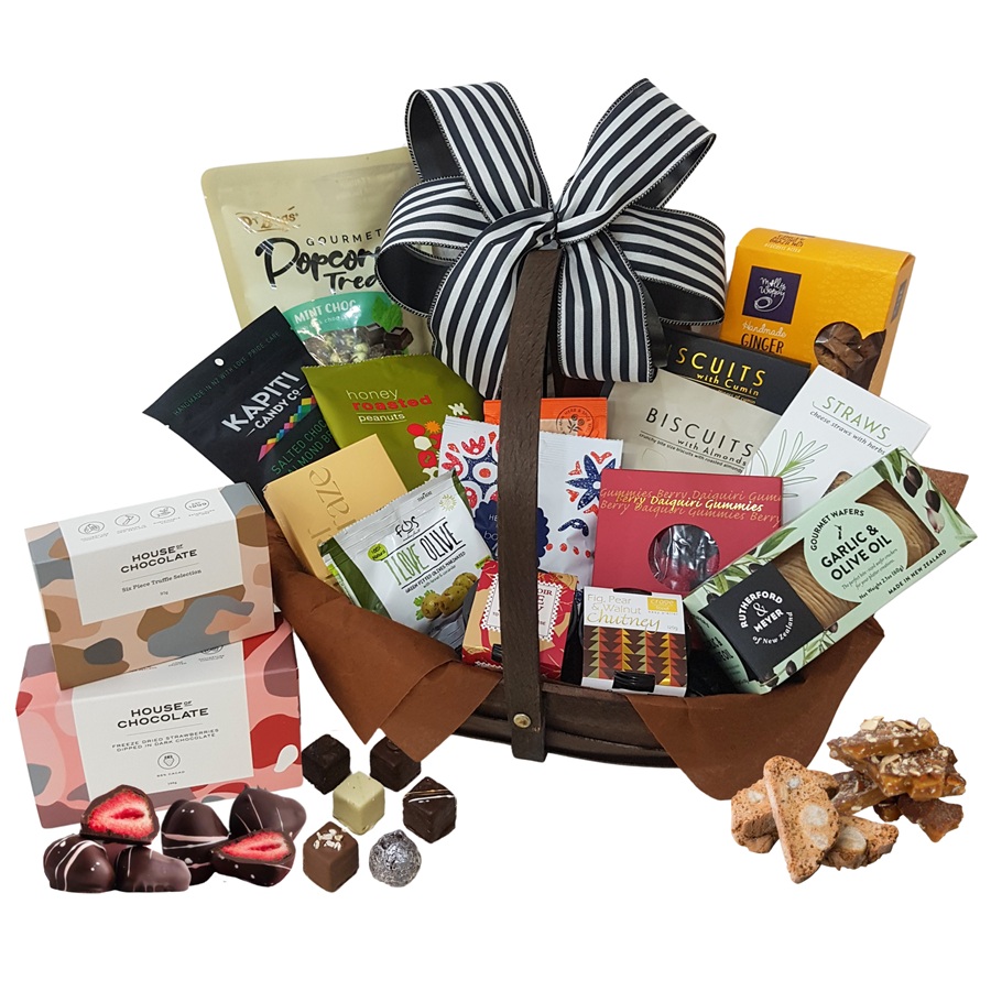 Deluxe luxury gift basket showing chocolates, biscuits and gourmet treats arranged in a wooden trug.