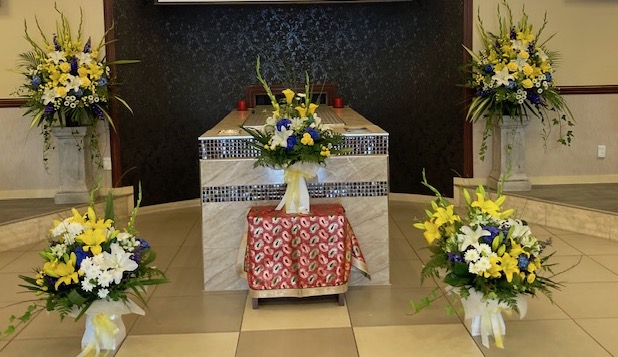yellow and white funeral setting of flowers for a large display