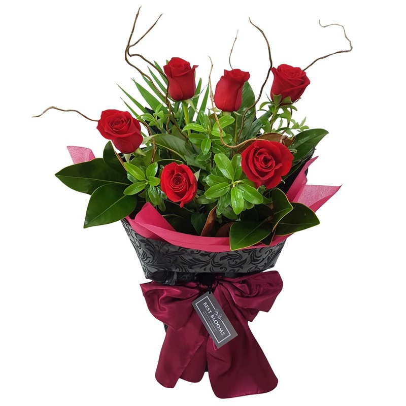 Valentines Bouquet of 6 Red Roses and tropical palm leaves. 