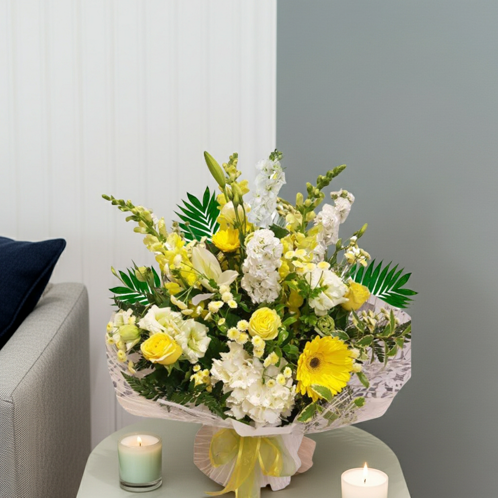 Harmony Bouquet Generous yellow and white flower bouquet with abundant seasonal blooms in bright and elegant tones in styled scene.