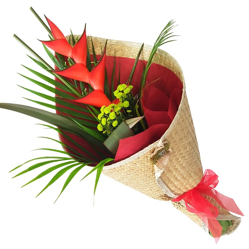 red heliconia flower gift wrapped in natural woven kete mat