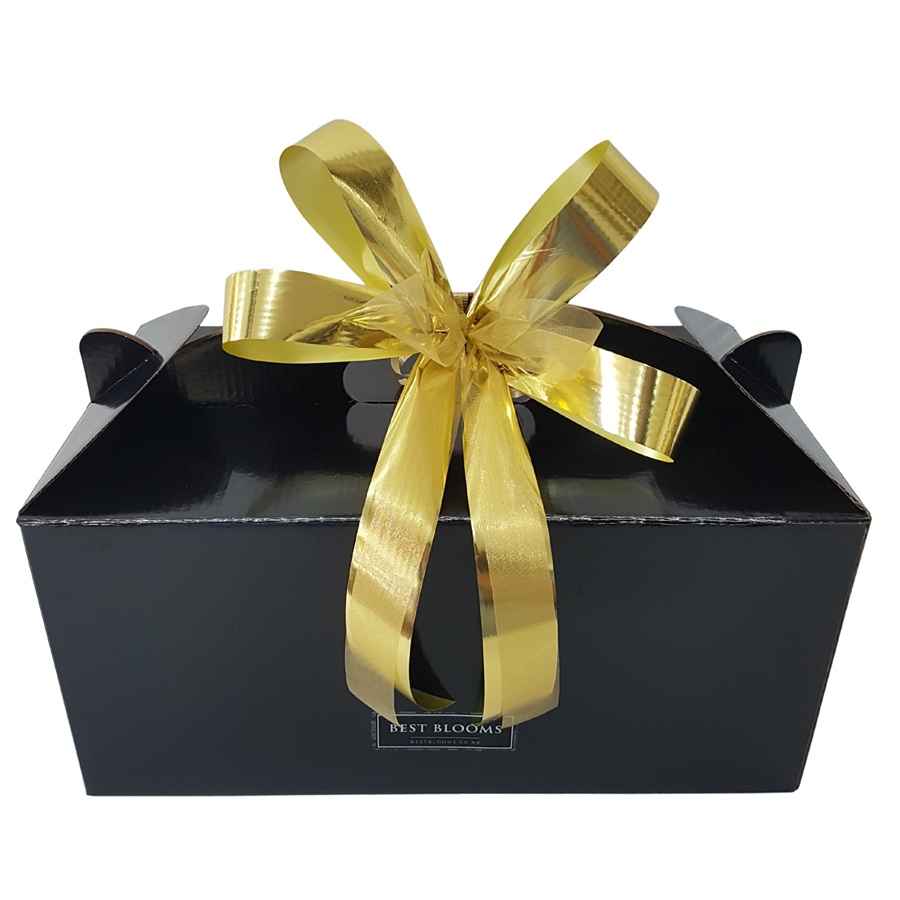 Jingle Bells Christmas Gift Box Christmas gift box filled with festive treats and ribbon presentation