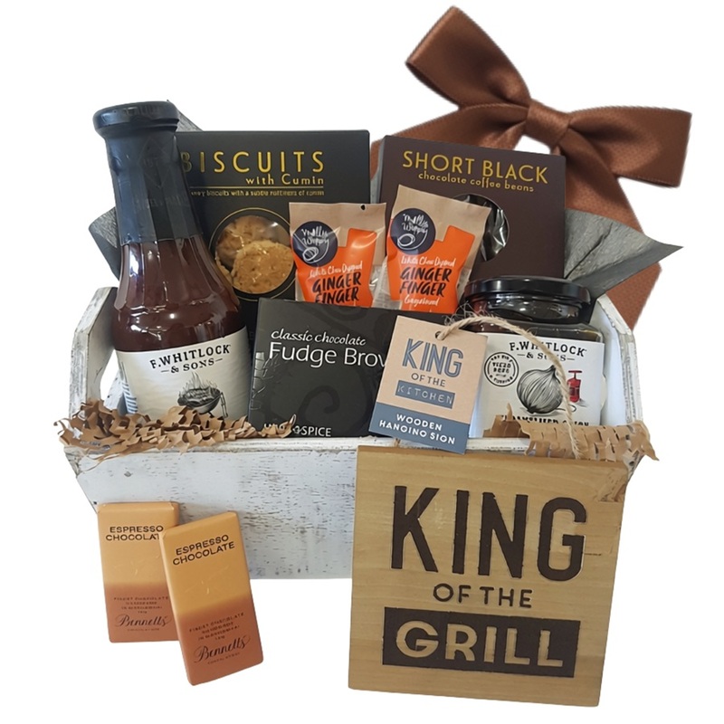 wooden crate of barbecue condiments and tasty treats