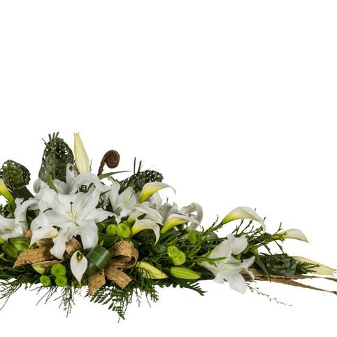close up view of white lily and flax flower casket spray