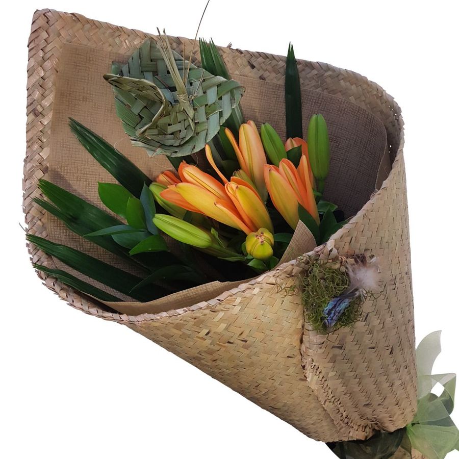 orange lilies in harakeke flax kete wrap, woven flax flower, palm leaf., 