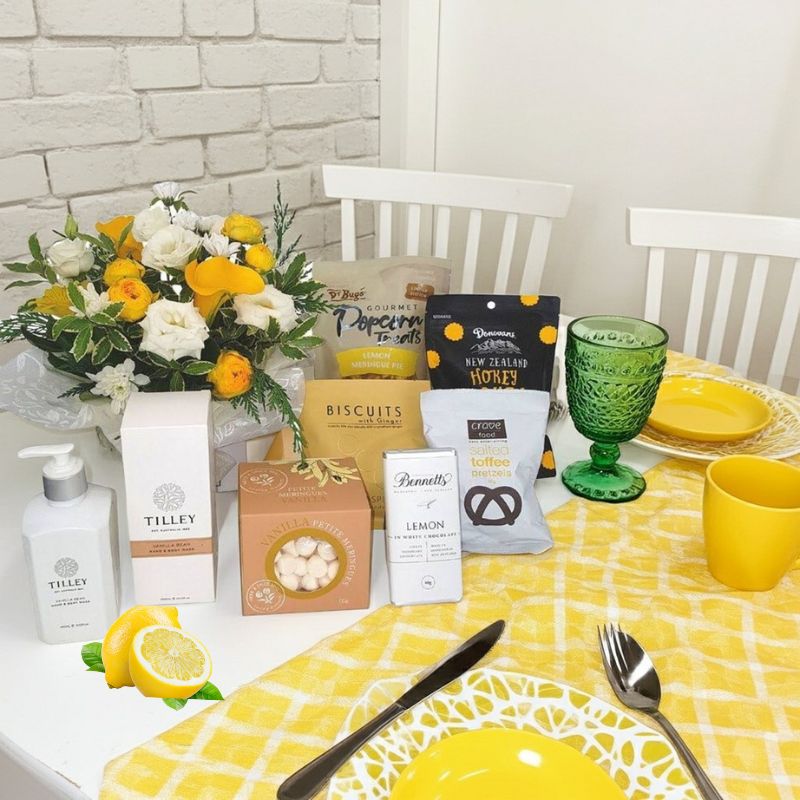 Flower gift box Auckland with lemon themed goodies in styled scene
