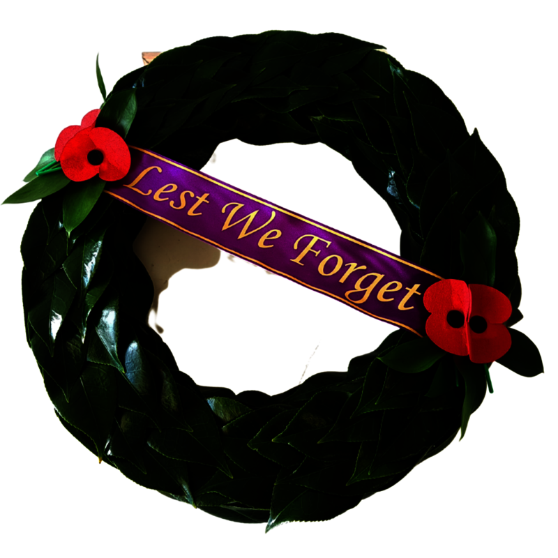 Anzac Wreath of traditional green leafing pattern of fresh leaves. Lest we Forget ribbon. RSA Red Poppies.