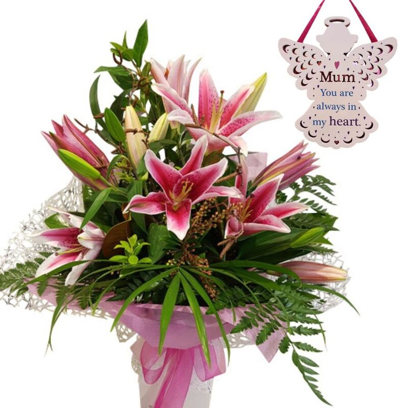 pink lilies bouquet auckland showing open lily flowers & fresh closed buds in pink wrapping and pink ribbon.