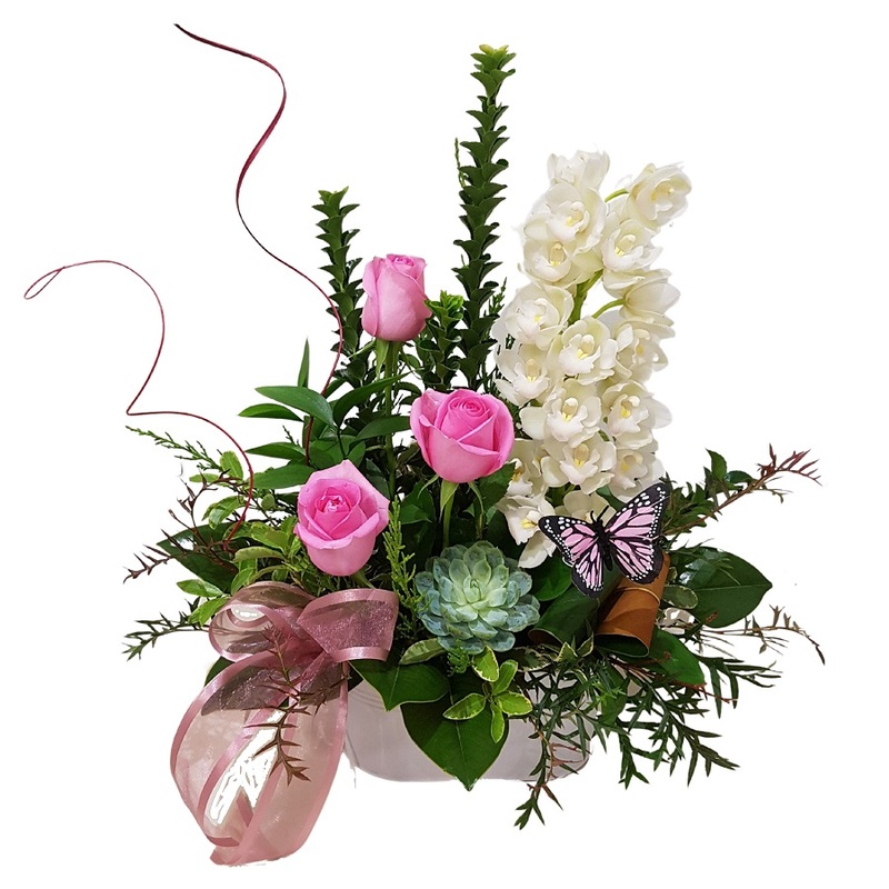 orchids and roses in floral arrangement with butterfly