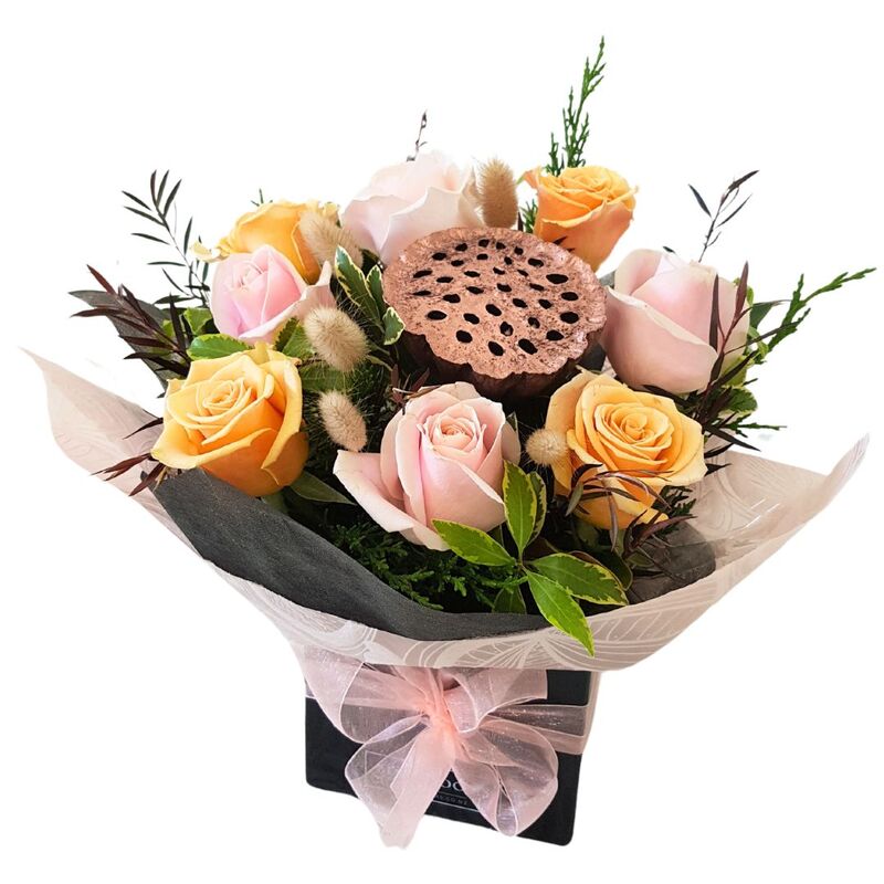 Arrangement of Roses in Pink and Peach roses with lotus pod, 
