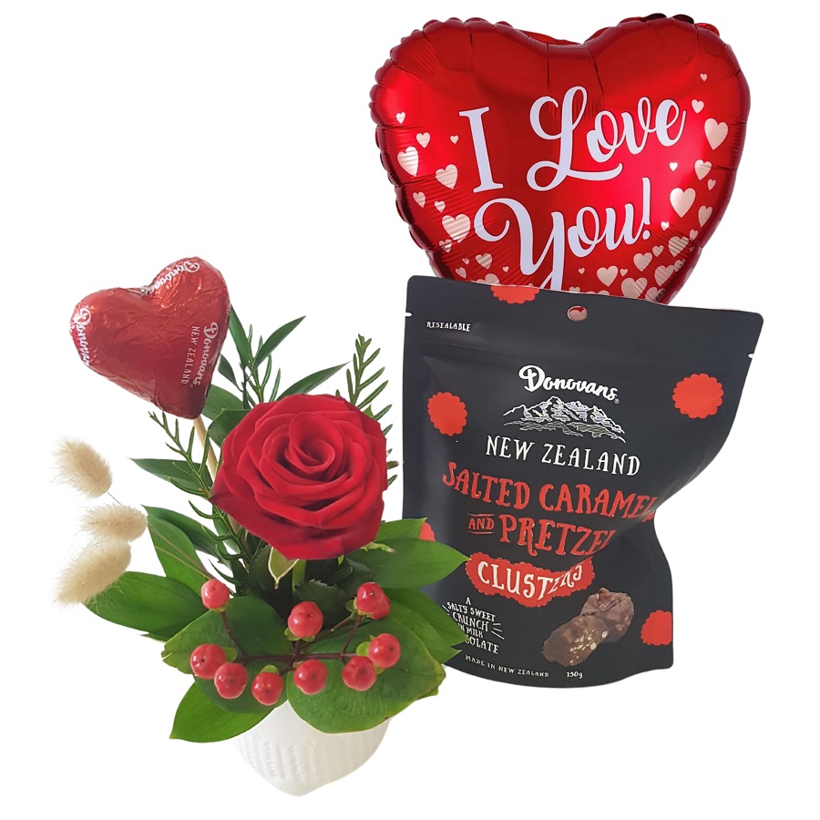Red rose with chocolates and a Valentines Day balloon