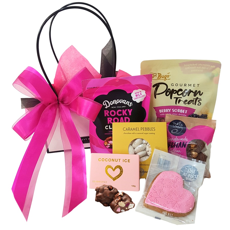 Sugar Babe pink themed Sweet Gift Box with chocolates, cookies and treats arranged in bright pink packaging.