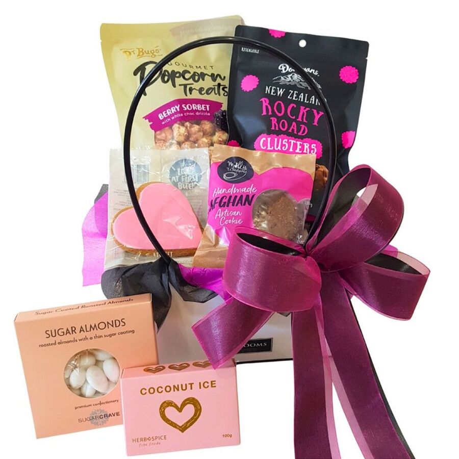 Pink themed gift basket with sweets, chocolates, cookies