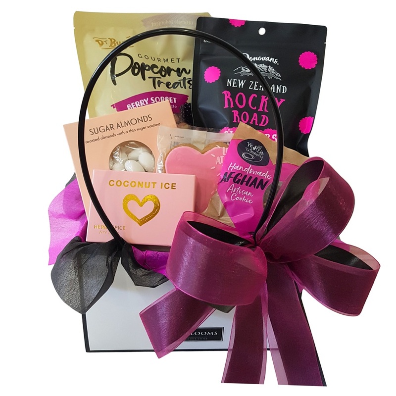 Close up of pink themed gift basket showing stylish pink and black ribbon and gift wrapping