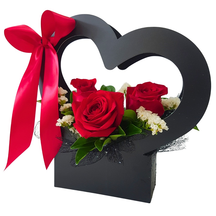 red roses arranged in a heart shaped gift box