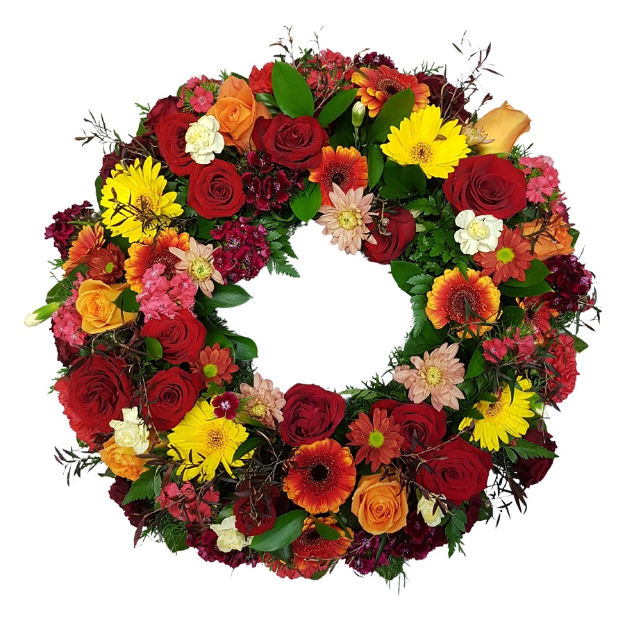 Funeral wreath for a Man in autumn colours. Reds, Orange flowers & Gold Seasonal Flowers. Orange roses, red carnations, Yellow chrysanthemums, leucadendrons., 
