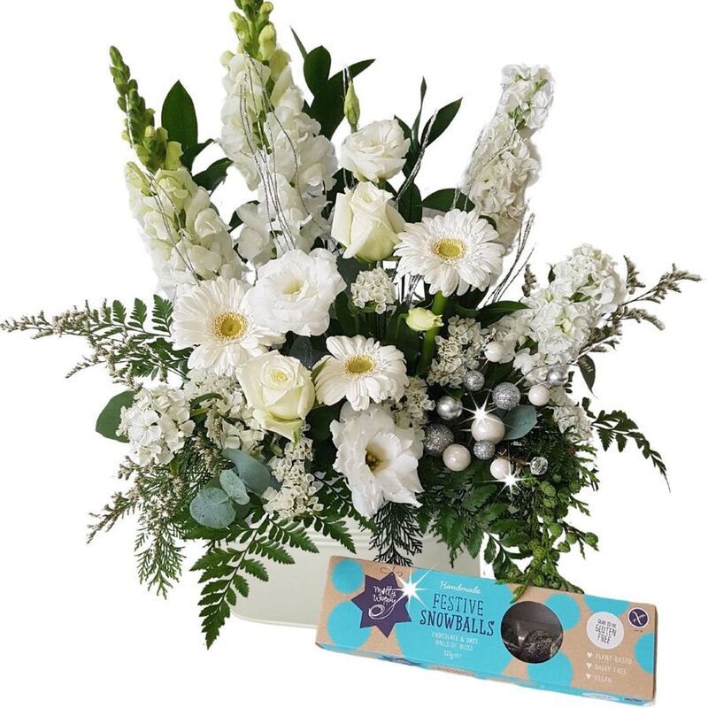 sparkly white Christmas flower arrangement with festive chocolate snowballs
