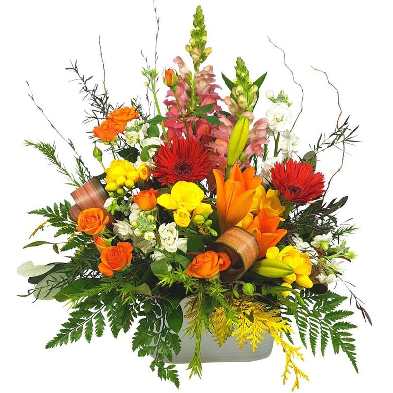 Cheerful flowers. Bright colourful Flower box Arrangement in tin trough. Cheerful Orange Lilies, gerberas, freesias, stock, alstroemarias. Auckland Florist Delivered., 