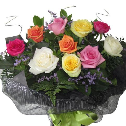 close up showing beautiful assorted rainbow colours of roses included in bouquet