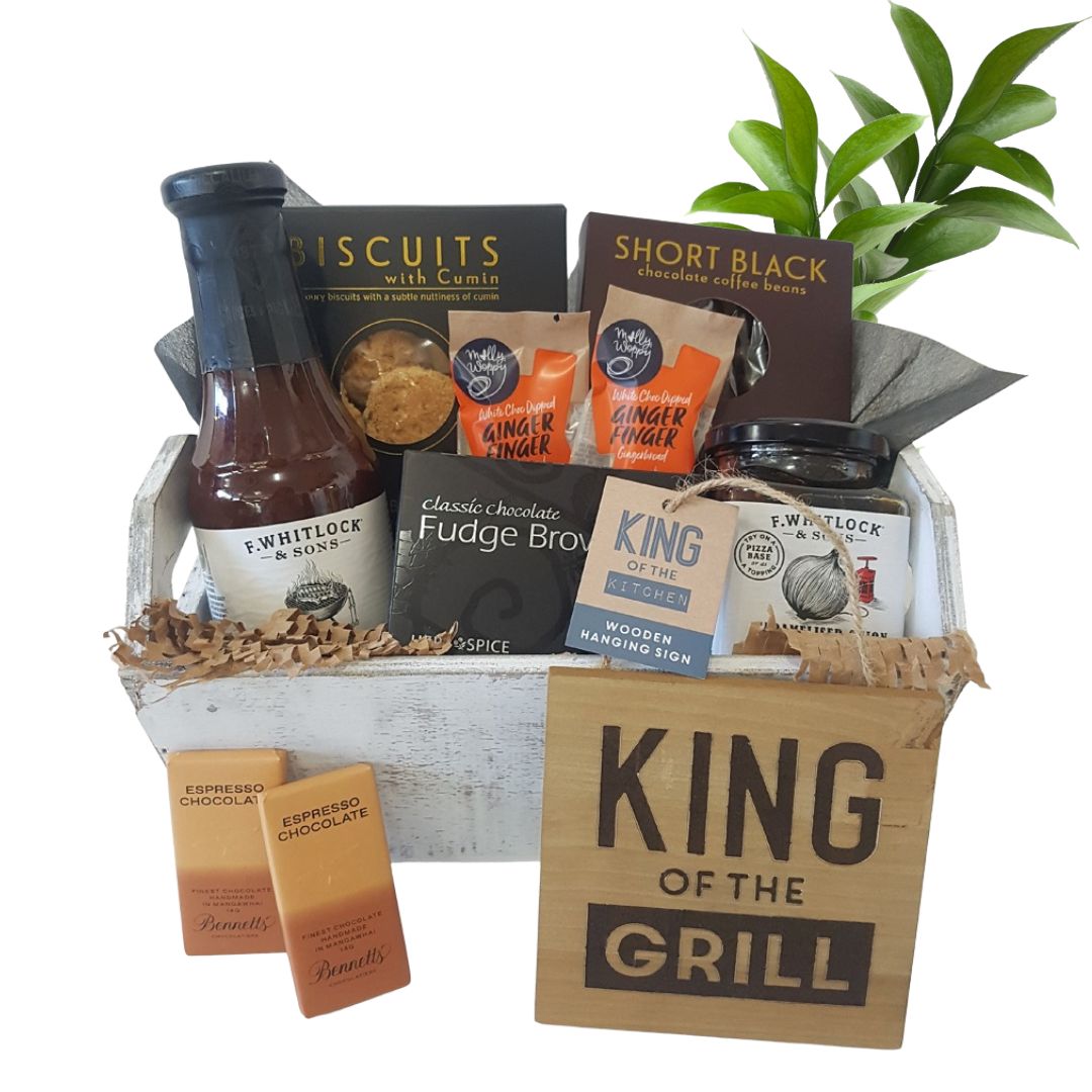 wooden crate of barbecue condiments and tasty treats
