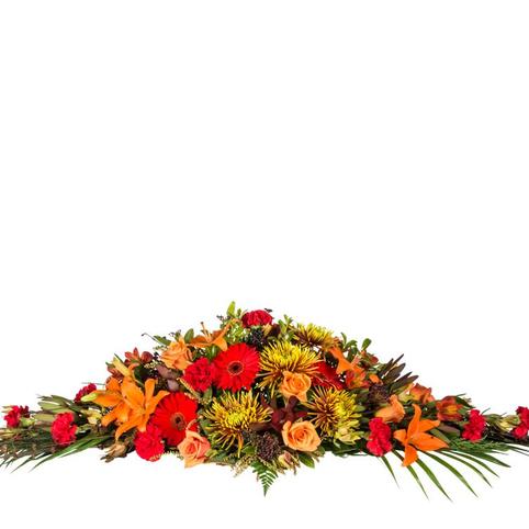 Autumn Tones Casket Spray casket spray in rich autumn colours. Full length spray in reds, oranges, gold toning flowers.
