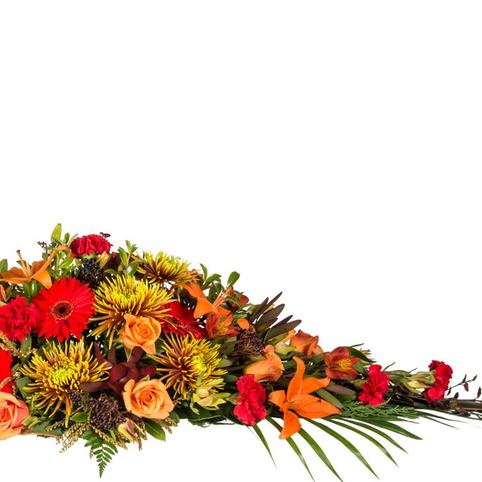 Autumn Tones Casket Spray side view of autumnal toned casket spray flowers. Gerberas, Lilies, Roses, Chrysanthemums.