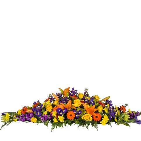 Bright Life Casket Spray bright funeral casket spray showing full length for top of coffin. Mixed bright colourful flowers in season.