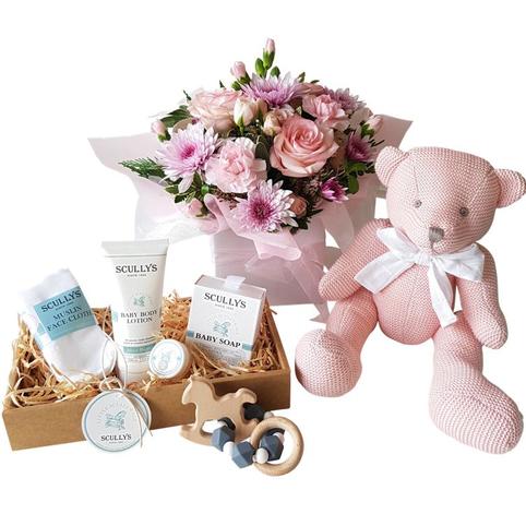 Baby Girl pink Gift Hamper delivered auckland includes cotton knit teddy bear and flowers, and scullywags baby care products.
