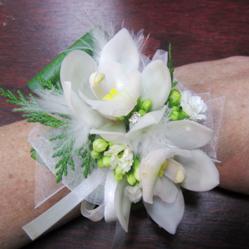 white orchid corsage with feather trim wristlet