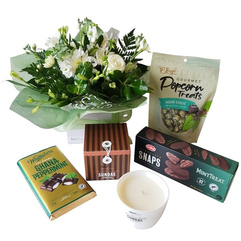 stylish gift box includes candles, flowers, chocolate peppermints