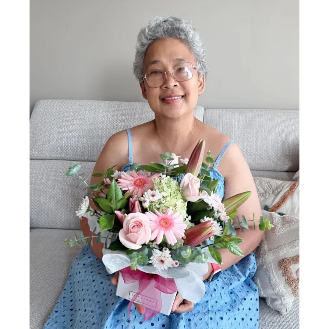 Mum receiving Mothers Day Flowers width=