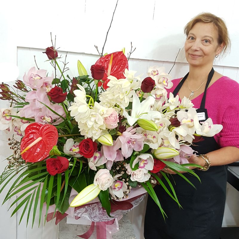 Large luxury flower bouquet with pink orchids, red roses, white lilies and red anthuriums