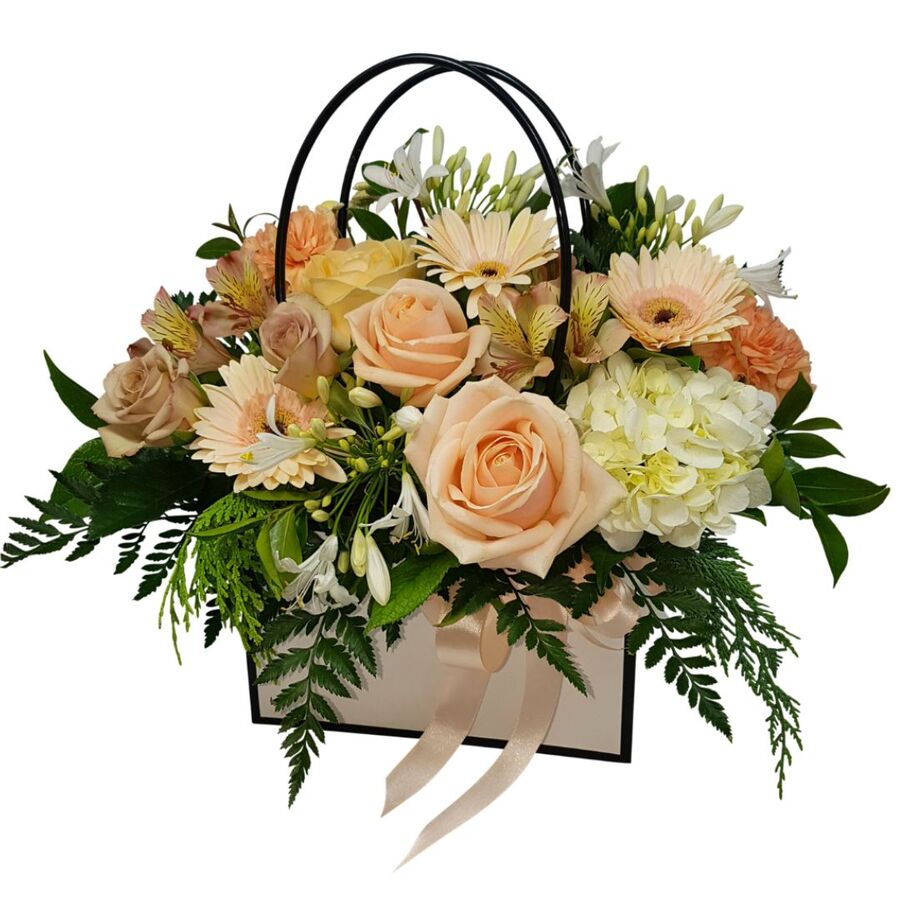 Gift of peach flowers arranged in handbag auckland