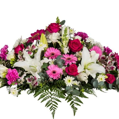 side view of pink and white casket spray florals