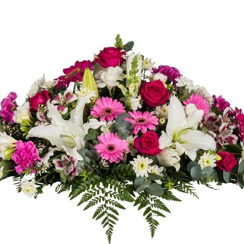 side view of pink casket spray florals