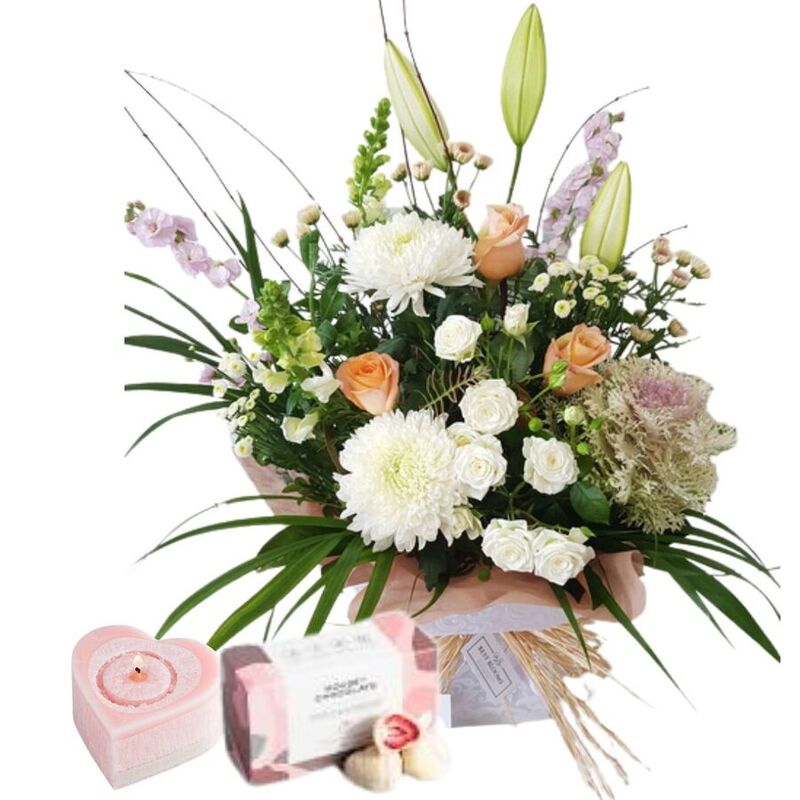 Romantic anniversary gift combo with pastel flowers, candle and chocolates