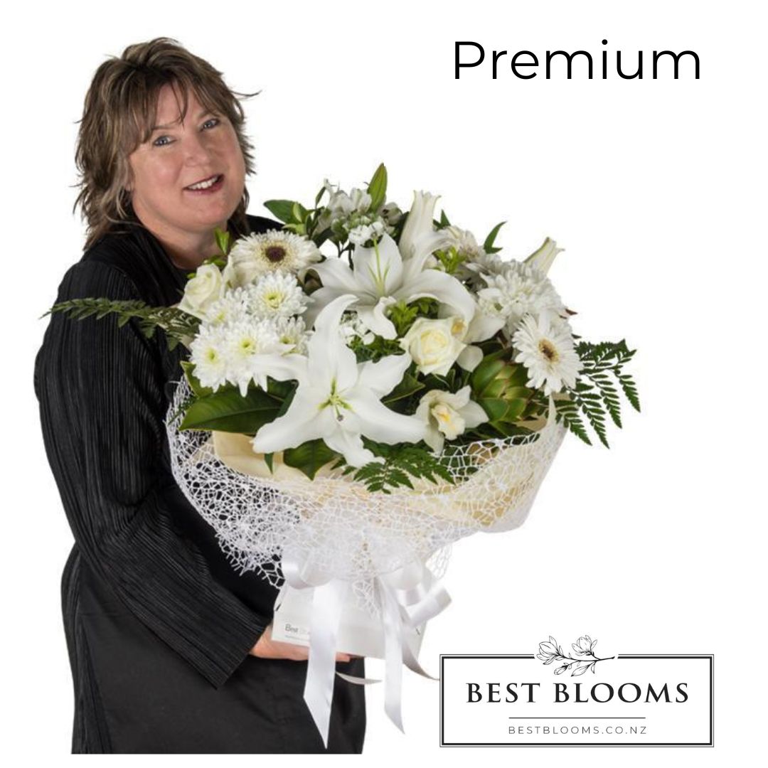 Owner Jo Moss holding the premium size white peace bouquet