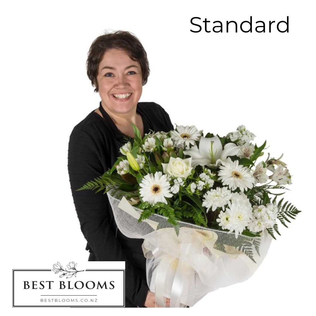 florist holding the standard size white sympathy bouquet
