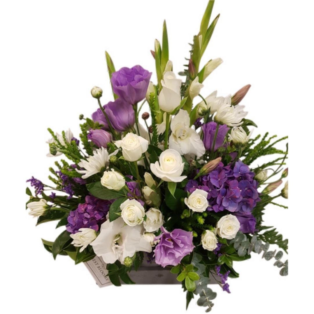 Purple flowers in wooden box of blooms